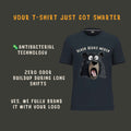 A dark navy graphic t-shirt featuring a cartoon bear face with wide eyes and its mouth open, with the text 'BLACK BEARS MERCH' above it. The image is set against a dark gray background with promotional text highlighting antibacterial technology, zero odor buildup, and custom branding.